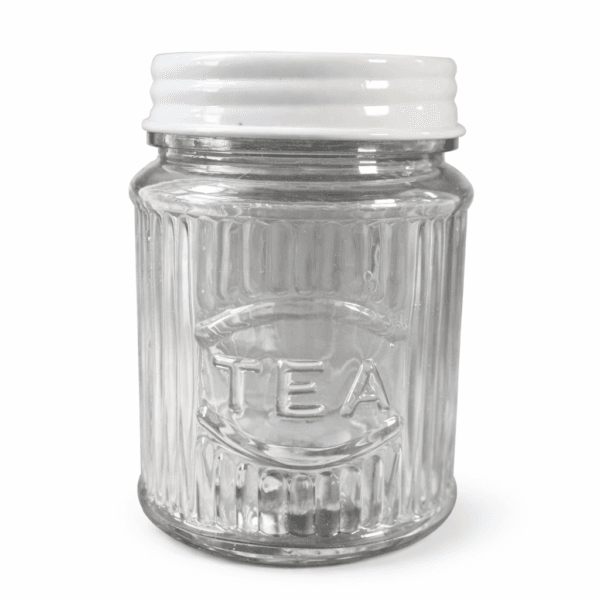 Glasburk med lock i metall, på burken finns texten ”Tea”. Diameter 10 cm, höjd 14 cm.