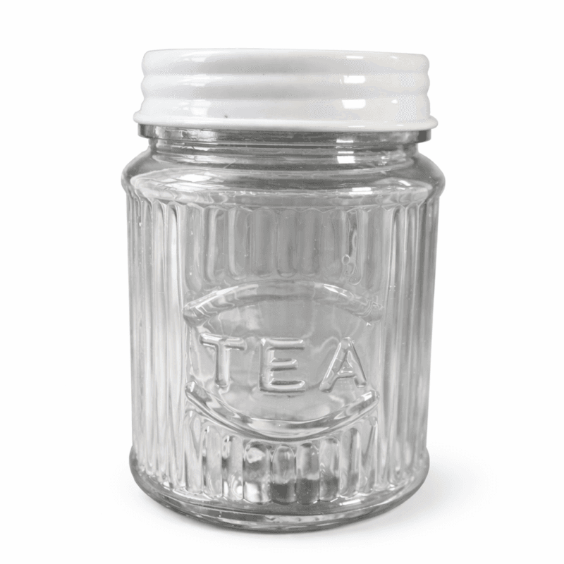 Glasburk med lock i metall, på burken finns texten ”Tea”. Diameter 10 cm, höjd 14 cm.