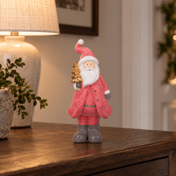 Dekorativ jultomte i keramik med röd glitterdekor och guldfärgad gran